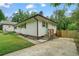 This home features white siding, a chimney, concrete steps, new deck with wooden railings, and mature trees at 2049 Rector Sw Dr, Atlanta, GA 30311