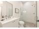 Bathroom with white vanity, framed mirror, glass enclosed shower, and decorative tile flooring at 370 2Nd St, Fayetteville, GA 30214