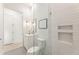 Bathroom with white vanity, framed mirror, glass enclosed shower, and decorative tile flooring at 370 2Nd St, Fayetteville, GA 30214