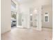 Bright bedroom featuring light hardwood floors, large windows, access to a balcony, and ensuite bath, all in a neutral palette at 370 2Nd St, Fayetteville, GA 30214