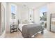 Bedroom with white linens and a gray throw blanket, with two large windows providing natural light at 370 2Nd St, Fayetteville, GA 30214