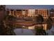 A scenic view of a large building complex beside a pond, reflecting off the water's surface at 370 2Nd St, Fayetteville, GA 30214
