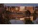 Exterior view of a building complex at night with pond in foreground at 370 2Nd St, Fayetteville, GA 30214