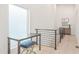 Landing area with a desk, stool, and modern railing providing a functional and stylish space at 370 2Nd St, Fayetteville, GA 30214