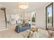 Open-concept living space featuring a staircase and modern kitchen with stainless appliances adjacent to living area at 370 2Nd St, Fayetteville, GA 30214