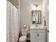 The bathroom features neutral tones, a single vanity, and a tub/shower combination with a white shower curtain at 4355 Parkside Pl, Sandy Springs, GA 30342