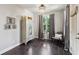 This room features dark hardwood floors, a chic armoire, a neutral color palette, and a bright window at 4355 Parkside Pl, Sandy Springs, GA 30342