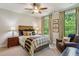 This cozy bedroom features windows providing natural light, complemented by elegant curtains and a comfortable reading chair at 4355 Parkside Pl, Sandy Springs, GA 30342