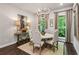 Bright dining room with chandelier, large windows, and seating for six around a round table at 4355 Parkside Pl, Sandy Springs, GA 30342