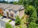 Townhome exterior with multiple balconies, brick accents, lush landscaping, and convenient parking spaces at 4355 Parkside Pl, Sandy Springs, GA 30342