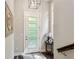 Light-filled foyer featuring a stylish front door, wood floors, and a charming side table at 4355 Parkside Pl, Sandy Springs, GA 30342