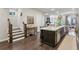 Spacious open layout featuring the kitchen island, dining area, and a staircase to the upper level at 4355 Parkside Pl, Sandy Springs, GA 30342