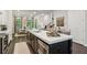 Kitchen featuring a large island, stainless steel appliances, and a view into the dining room at 4355 Parkside Pl, Sandy Springs, GA 30342
