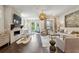 Open-concept living room featuring a fireplace, hardwood floors, and natural light at 4355 Parkside Pl, Sandy Springs, GA 30342