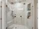 The shower includes frameless glass, marble walls, rain shower heads and tiled shelving at 4355 Parkside Pl, Sandy Springs, GA 30342