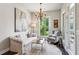 Cozy sitting area boasts a tufted sofa, natural light, and serene decor at 4355 Parkside Pl, Sandy Springs, GA 30342