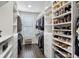 This walk-in closet has built-in shelving for shoes, drawers, and hanging storage for organization at 4355 Parkside Pl, Sandy Springs, GA 30342