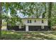 Backyard view of the two-story home featuring two-toned white and black siding at 623 Montevista Sw St, Atlanta, GA 30310