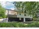 Exterior view of the home's backyard with a raised porch and black and white painted siding at 623 Montevista Sw St, Atlanta, GA 30310