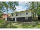 Back view of house with white and black two-tone paint, surrounded by lush greenery at 623 Montevista Sw St, Atlanta, GA 30310