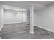 Finished basement area featuring gray wood-look floors, white painted walls, and a bright window at 623 Montevista Sw St, Atlanta, GA 30310