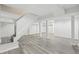 Spacious finished basement featuring modern flooring, columns and staircase at 623 Montevista Sw St, Atlanta, GA 30310