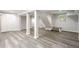 Finished basement area with modern flooring, support pillars, and a staircase at 623 Montevista Sw St, Atlanta, GA 30310