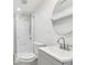 Bathroom features a tile shower, modern fixtures, white vanity, and round mirror at 623 Montevista Sw St, Atlanta, GA 30310