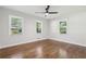 A bright bedroom with three windows, hardwood floors and a ceiling fan at 623 Montevista Sw St, Atlanta, GA 30310