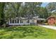 Charming single-story home with white brick, dark shutters, and a well-manicured lawn at 623 Montevista Sw St, Atlanta, GA 30310