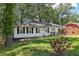 Charming single-story home with white brick, dark shutters, and a well-manicured lawn at 623 Montevista Sw St, Atlanta, GA 30310