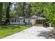Charming single-story home with white brick, dark shutters, and a covered parking area at 623 Montevista Sw St, Atlanta, GA 30310