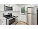 Modern kitchen with stainless steel appliances, white cabinets, and subway tile backsplash at 623 Montevista Sw St, Atlanta, GA 30310