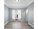 Bright, empty bedroom with hardwood floors, white trim, and natural light at 628 Warren Ave, Scottdale, GA 30079