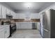 Modern kitchen featuring stainless steel appliances, white cabinets and stone countertops at 628 Warren Ave, Scottdale, GA 30079
