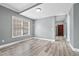 Cozy living room with hardwood floors, a large window, and neutral colored walls at 628 Warren Ave, Scottdale, GA 30079