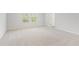 Spacious bedroom featuring plush neutral carpet, natural light, and a doorway to the hallway at 7193 Brushwood Bend (Lot 33), Lithonia, GA 30058