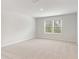 Spacious bedroom with carpet flooring and natural light from a large window at 7193 Brushwood Bend (Lot 33), Lithonia, GA 30058