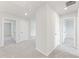 Hallway showcasing multiple entryways, neutral walls, and plush carpeting at 7193 Brushwood Bend (Lot 33), Lithonia, GA 30058
