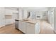 Open kitchen showcasing a granite island, stainless steel appliances, and seamless flow to the living area at 7193 Brushwood Bend (Lot 33), Lithonia, GA 30058