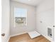 Laundry room with storage shelf, hookups, window, and wood-look flooring at 7193 Brushwood Bend (Lot 33), Lithonia, GA 30058