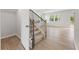 Entry to living room featuring hardwood floors, staircase with iron spindles, and a fireplace at 7193 Brushwood Bend (Lot 33), Lithonia, GA 30058