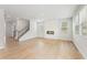 Bright living room features hardwood floors, a modern fireplace, and lots of natural light through large windows at 7193 Brushwood Bend (Lot 33), Lithonia, GA 30058