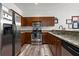 Well-equipped kitchen with stainless steel appliances, granite countertops, and wood finish cabinets and light woodgrain flooring at 870 Mayson Turner Rd Nw # 1111, Atlanta, GA 30314