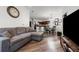 Comfortable living room with open sight lines to kitchen and dining area and featuring a gray couch and wood flooring at 870 Mayson Turner Rd Nw # 1111, Atlanta, GA 30314