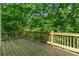 The wooden deck features a view of the wooded backyard at 140 Longwater Cv, Roswell, GA 30075