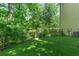 The backyard features a black metal fence and staircase leading to a wood deck at 140 Longwater Cv, Roswell, GA 30075