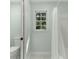 Full bathroom with tiled shower and tub combination and window with lots of natural light at 140 Longwater Cv, Roswell, GA 30075