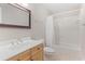 This bathroom features a wood vanity, a large mirror, and a shower/tub combo at 140 Longwater Cv, Roswell, GA 30075