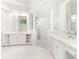 This renovated bathroom boasts lots of cabinet storage, dual sinks, and modern fixtures at 140 Longwater Cv, Roswell, GA 30075